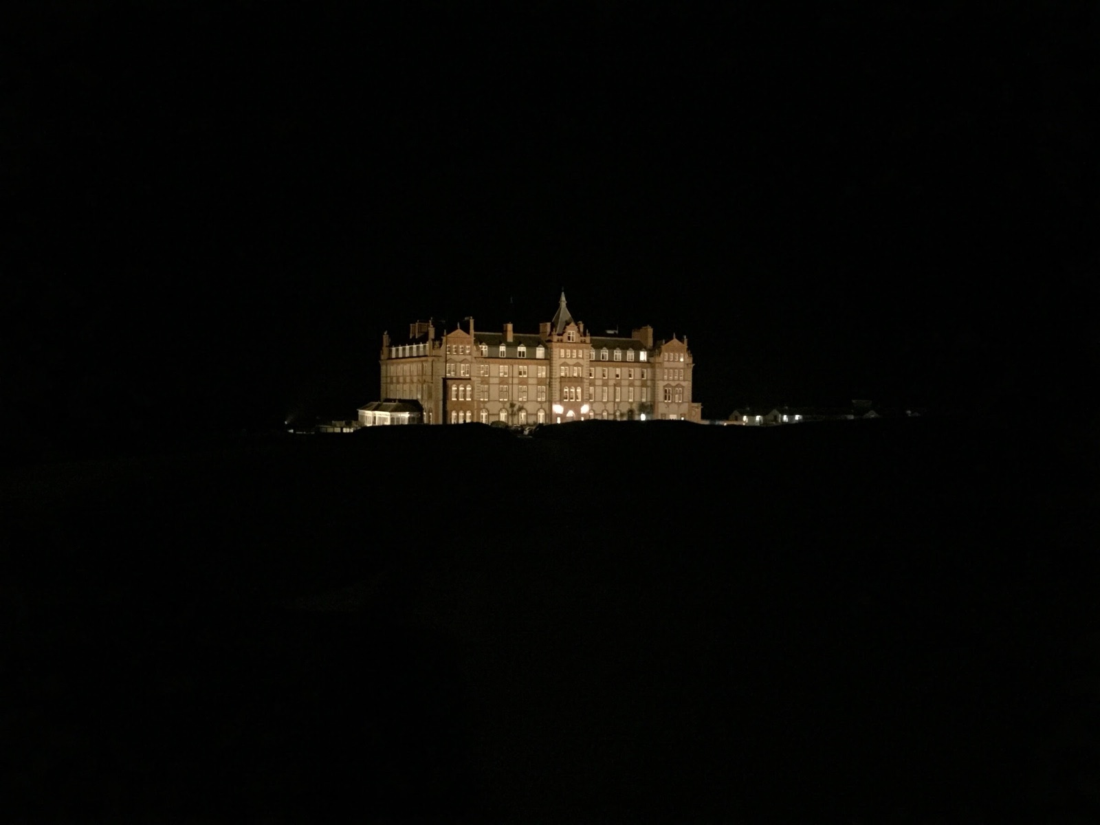A hotel lit up against a black night sky
